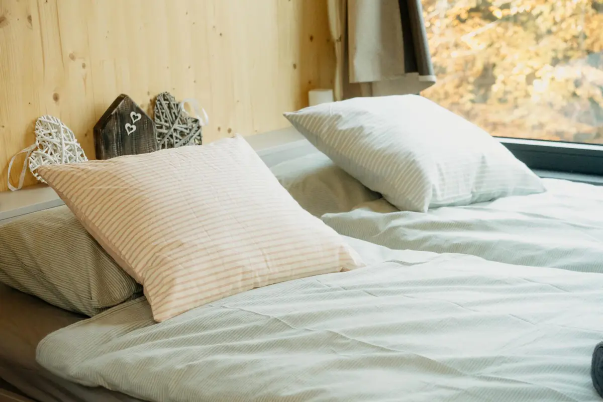 Made bed with white linen